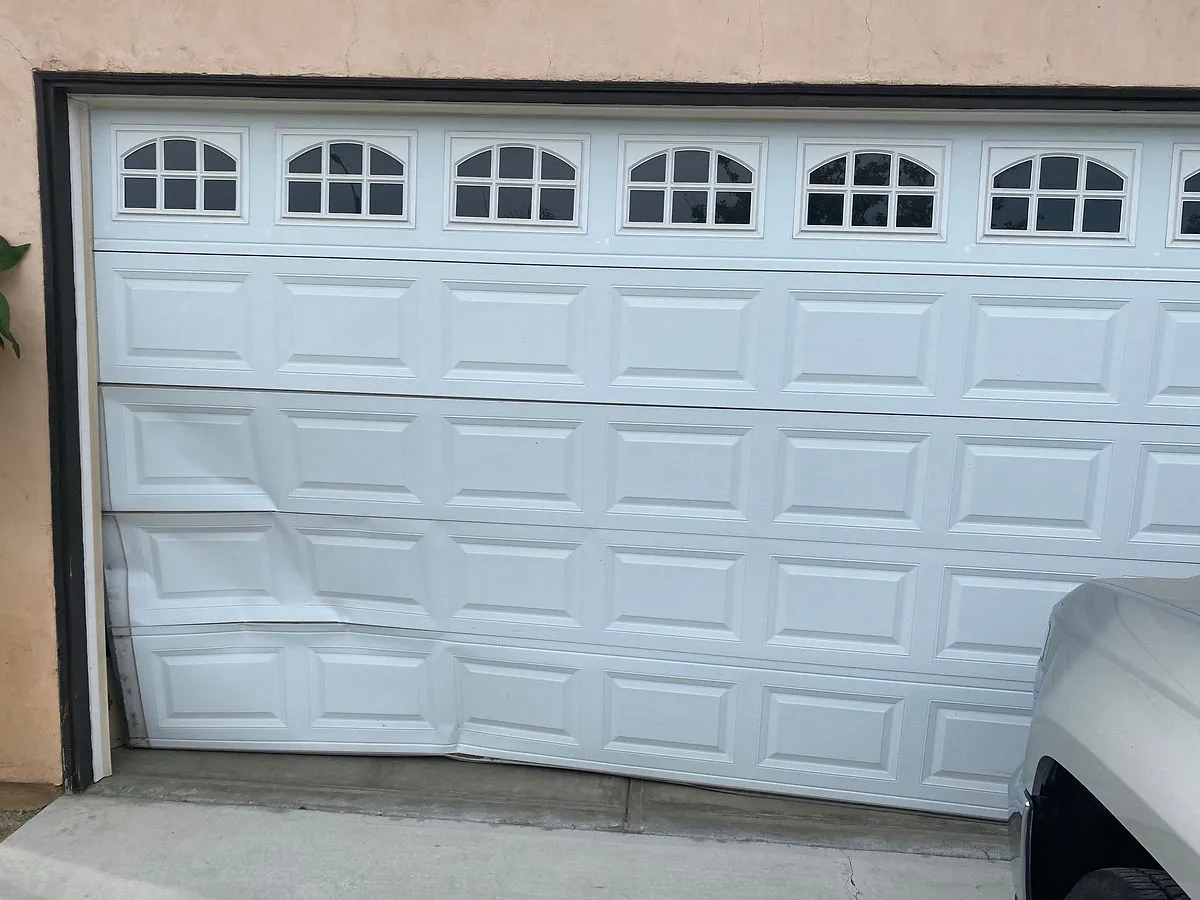 A damaged garage door that needs repair