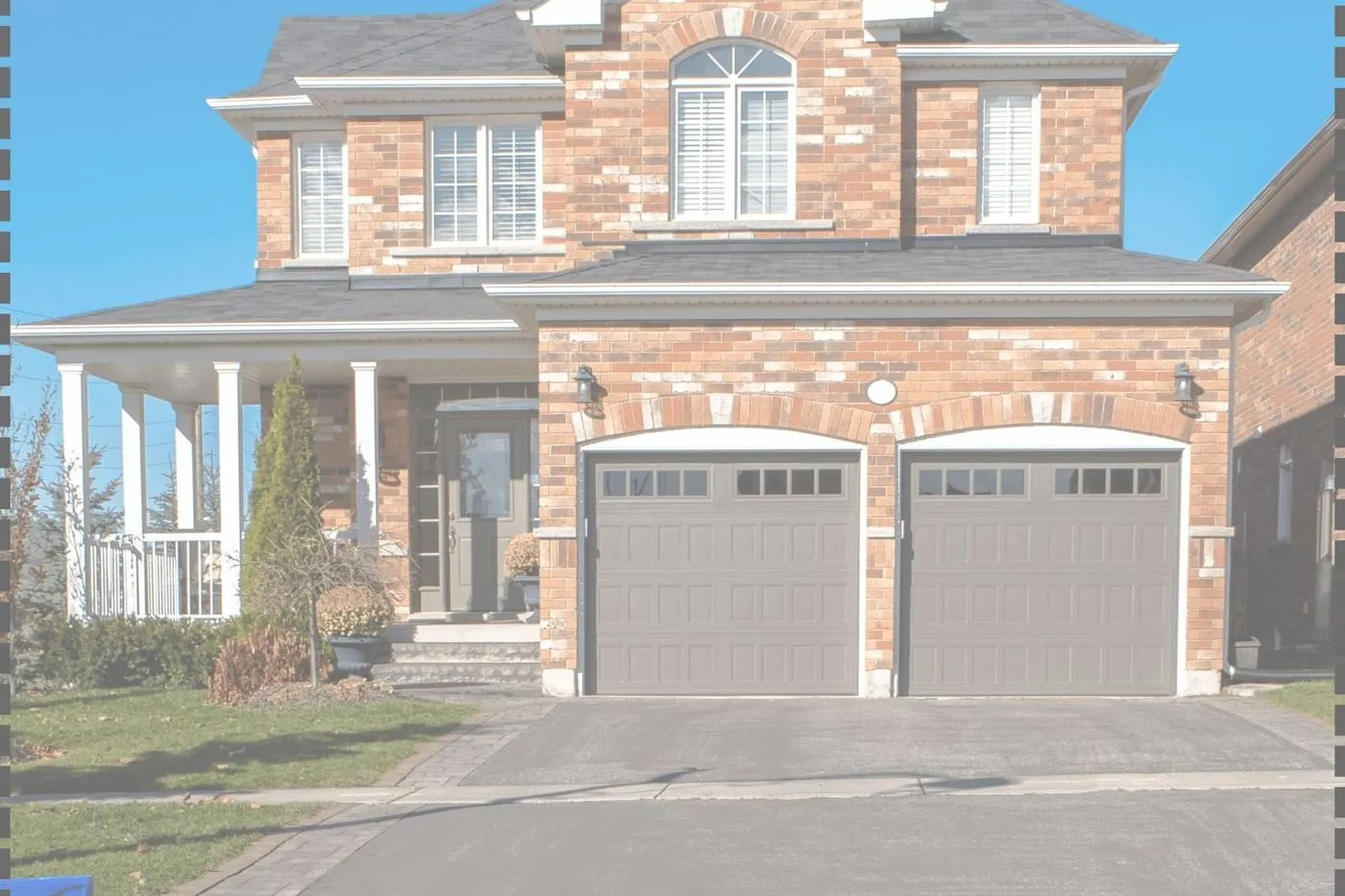 A brick house with double garage doors